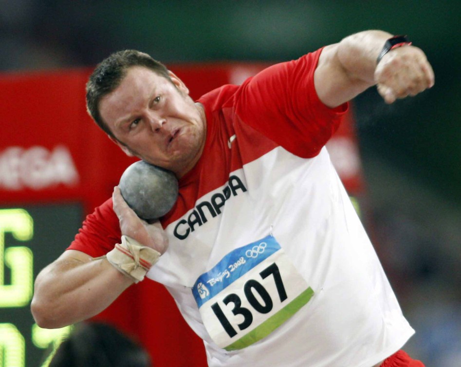 Dylan Armstrong with the shot tucked under his chin ready to throw it