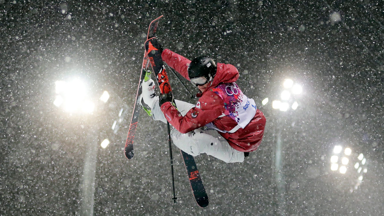 Mike Riddle during one of his runs in heavy snow at the Sochi ski halfpipe competition.